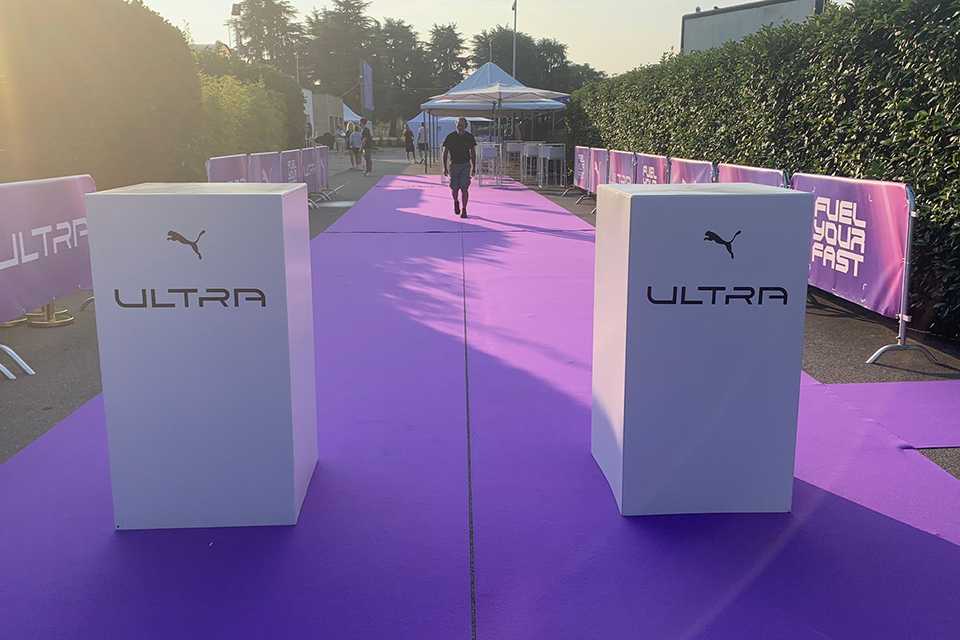 PUMA ULTRA Event: Lila Teppich, weiße Podeste mit PUMA Logo. Fuel Your Fast.